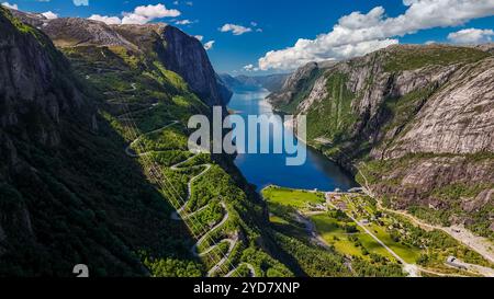 Kjerag, Lysebotn, Lysefjorden, Norvegia una vista aerea di una strada tortuosa che serpeggia attraverso i lussureggianti e verdi pendii montani che si affacciano Foto Stock