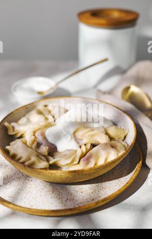 Gnocchi con ciliegie con panna acida e zucchero. Piatto tradizionale di cucina russa, Ucraina e bielorussa conosciuto come Vareniki Foto Stock