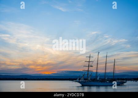 Sicilia, Italia. 25 ottobre 2024. Star Flyer, una nave Star Clipper, lascia il porto mentre il sole tramonta sul porto. Si tratta di moderne navi da crociera create per i passeggeri che amano le tradizioni dell'era delle navi a vela. Le navi sono lunghe 115 metri e trasportano 166 ospiti. Autunno a Siracusa, Sicilia, Italia. Crediti: Guy Bell/Alamy Live News Foto Stock