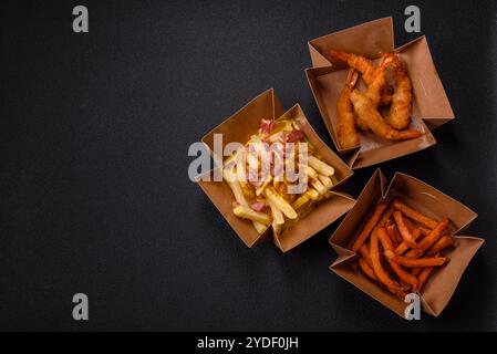 Patatine fritte croccanti con pezzi di pancetta, sale e spezie Foto Stock