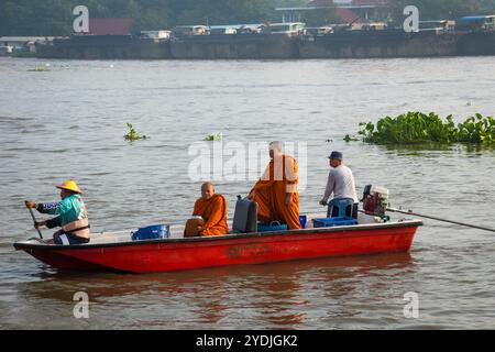 Thailandia. 25 ottobre 2024. I monaci sono visti all'interno di una barca di legno con cesti di elemosina, sul fiume Chao Phraya. La tradizione di dare l'elemosina a un centinaio di monaci a Pathum Thani, Thailandia, è una cerimonia buddista secolare che si svolge lungo fiumi e canali dopo la fine della Quaresima buddista. I monaci si riuniscono in barca per ricevere offerte dalla gente del posto, che prepara il cibo e partecipa alla preparazione del merito. Questo evento celebra la comunità, la fede e il patrimonio culturale. (Foto di Nathalie Jamois/SOPA Images/Sipa USA) credito: SIPA USA/Alamy Live News Foto Stock