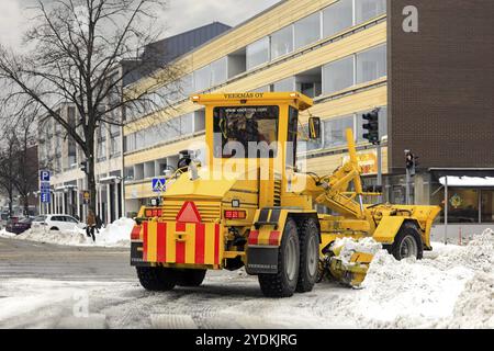 Il motorgrader giallo Veekmas FG 2327 S rimuove la neve dalle strade della città dopo le forti nevicate di gennaio. Salo, Finlandia. 22 gennaio 2021 Foto Stock