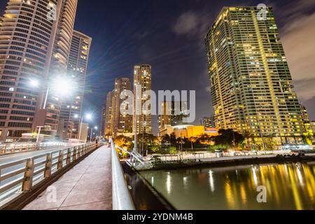 Lungo il fiume principale, attraversa uno dei quartieri centrali più esclusivi di Manila, i condomini e gli uffici si illuminano, illuminati in modo luminoso Foto Stock