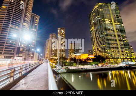 Lungo il fiume principale, attraversa uno dei quartieri centrali più esclusivi di Manila, i condomini e gli uffici si illuminano, illuminati in modo luminoso Foto Stock