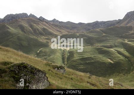 un'ampia collina coperta da erba verde e soffice e macchie di muschio. Le dolci pendenze lasciano il posto a un terreno più accidentato man mano che si innalzano Foto Stock