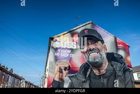 Un'immagine colorata del murale di Jurgen Klopp raffigurato vicino allo stadio Anfield di Liverpool, visto il 27 ottobre 2024 sotto un cielo blu. Foto Stock