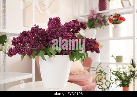 Vaso con lillas sul tavolo in studio fioraio Foto Stock