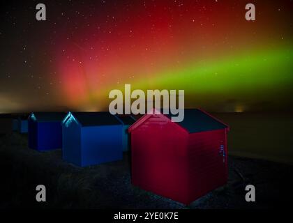 Aurora boreale, aurora boreale sulle Findhorn Beach Huts sulla costa di Moray in Scozia Foto Stock