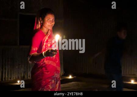 FENI, BANGLADESH - 17 OTTOBRE: Una ragazza si illumina durante il "Deep Utsav or Light festival" prima del festival Diwali a Feni, Bangladesh, il 17 ottobre, Foto Stock