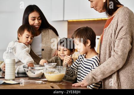 Una famiglia allegra ama cucinare dolci natalizi nella sua accogliente cucina mentre si prepara per il Natale. Foto Stock