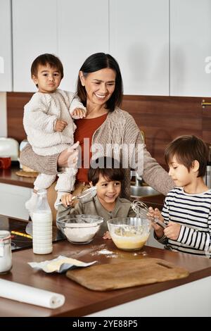 Una nonna gioiosa è circondata dai suoi nipoti mentre preparano insieme deliziosi dolcetti per Natale. Foto Stock