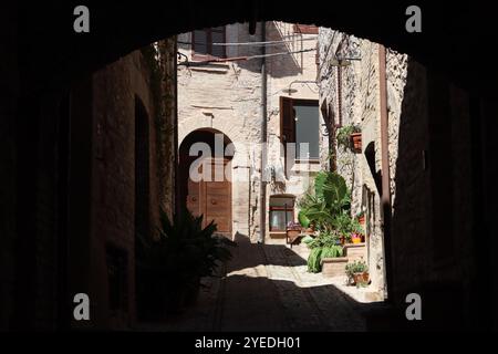 Vista attraverso un arco lungo una stretta strada secondaria in una città vecchia Foto Stock