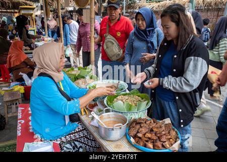 Yogyakarta-Indonesia, 21 settembre 2024: Vecchie donne indonesiane che vendono cibo tradizionale giavanese al festival Pasar Lawas Mataram, a Kota Gede, Yogyak Foto Stock