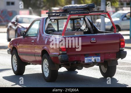 Una Subaru Brumby rossa parcheggiata sul lato di una strada suburbana. Foto Stock