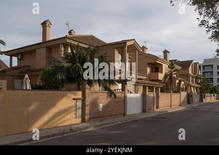 Da un lato della strada, vista sul lato opposto, con diversi edifici in stile chalet classico, facciate in mattoni a vista e costruzione moderna Foto Stock