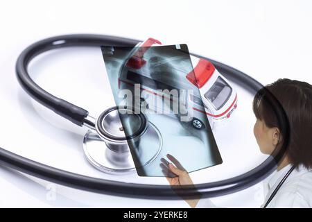 Composito di medico femminile con pellicola radiologica e ambulanza giocattolo Foto Stock