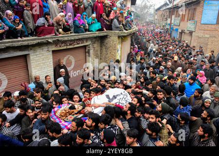 Un gran numero di persone assiste al funerale del presunto militante Shakir Hassan Dar nel villaggio di Rathsuna nel distretto di Tral nel Kashmir amministrato dall'India il 27 novembre 2018. Dar, che si dice appartenga al gruppo militante di Ansar Ghazwat-ul-Hind, è stato ucciso in uno scontro a fuoco con le forze indiane nell'area di Reshipora a Tral. Lo scontro a fuoco a Tral seguì dopo che le forze indiane avevano cordonato un'area per confrontarsi con i militanti che si credevano fossero in essa. Due militanti del gruppo Lashker-e-Taiba sono stati uccisi nell'incontro Foto Stock