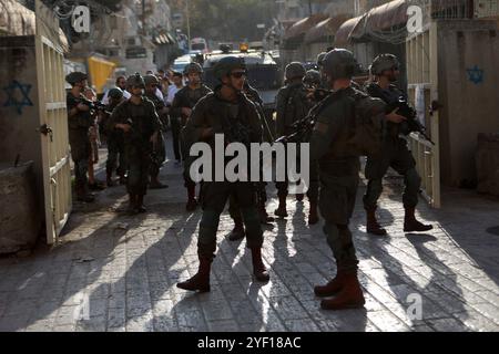 I coloni israeliani sono scortati da soldati israeliani durante un tour del mercato nella parte palestinese della città vecchia i coloni israeliani sono scortati da soldati israeliani durante un tour del mercato nella parte palestinese della città vecchia di Hebron nella Cisgiordania occupata il 2 novembre 2024. Foto di Mamoun Wazwaz apaimages Hebron Cisgiordania territorio palestinese 021124 Hebron MW 0045 Copyright: XapaimagesxMamounxWazwazxxapaimagesx Foto Stock