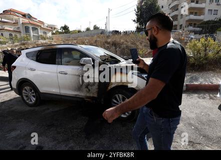 I palestinesi ispezionano i loro veicoli bruciati nel sito dove i coloni israeliani hanno attaccato ad al-Bireh vicino alla Cisgiordania i palestinesi ispezionano i loro veicoli bruciati nel sito dove i coloni israeliani hanno attaccato ad al-Bireh vicino alla città di Ramallah, in Cisgiordania, il 4 novembre 2024. In accordo con l'Agenzia WAFA, i coloni israeliani hanno dato fuoco a circa 20 veicoli di proprietà palestinese all'alba di lunedì dopo aver attaccato la città di al-Bireh. La gente del posto ha detto all'agenzia della WAFA che i coloni hanno aperto il fuoco in aria e ai veicoli della difesa civile quando sono arrivati nella zona per spegnere l'incendio prima di fuggire. Secondo un-OCHA Foto Stock