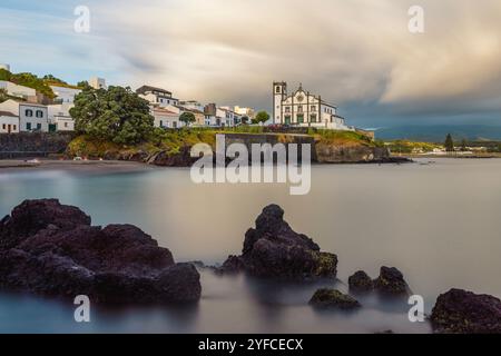 Vista sulla Praia de São Roque verso la chiesa di São Roque al tramonto. Foto Stock