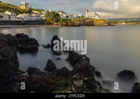 Vista sulla Praia de São Roque verso la chiesa di São Roque al tramonto. Foto Stock