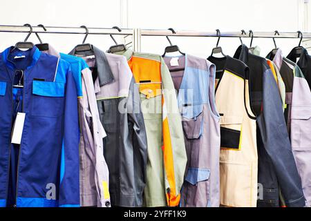 Abiti per lavoratori su un appendiabiti in negozio Foto Stock
