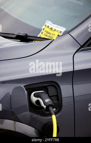 Un'auto elettrica riceve un biglietto per il parcheggio al Wythenshawe Forum Foto Stock