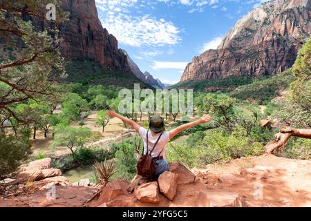 una ragazza escursionista ammira il tramonto primaverile nel parco nazionale di zion, l'incredibile tramonto sul possente canyon nello utah, stati uniti Foto Stock