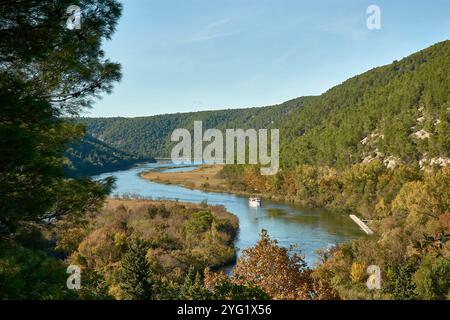 Una barca turistica che naviga attraverso lo splendido Parco Nazionale di Krka in Croazia, viaggiando dalla città di Skradin alle famose cascate di Skradinski Buk Foto Stock