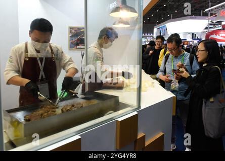 Shanghai. 6 novembre 2024. I visitatori assaggiano la carne di manzo uruguaiana durante la settima China International Import Expo (CIIE) nella zona orientale di Shanghai, 6 novembre 2024. I prodotti alimentari e agricoli esposti al CIIE hanno attirato l'attenzione dei visitatori. Crediti: Xu Liang/Xinhua/Alamy Live News Foto Stock