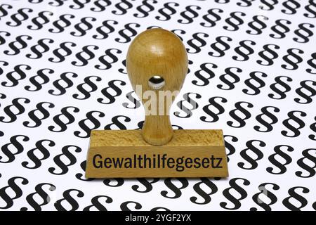 Stempel mit Gewalthilfegesetz auf Paragrafen Stempel mit Gewalthilfegesetz auf Paragrafen, 07.11.2024, Borkwalde, Brandeburgo, Ein Stempel mit Gewalthilfegesetz befindet sich auf Paragrafenzeichen. *** Stamp with Violence Assistance Act on paragraph Stamp with Violence Assistance Act on Article, 07 11 2024, Borkwalde, Brandeburgo, Un timbro con la violenza Assistance Act è sul segno del paragrafo Foto Stock