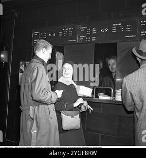 Al cinema 1958. Una giovane coppia di fronte alla cassiera per comprare i biglietti per il film. Kristoffersson rif CC74-8 *** didascalia locale *** Foto Stock