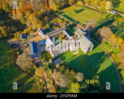 Pluscarden Abbey un monastero cattolico benedettino vicino a Elgin in Scozia circondato da alberi colorati durante il sole autunnale Foto Stock