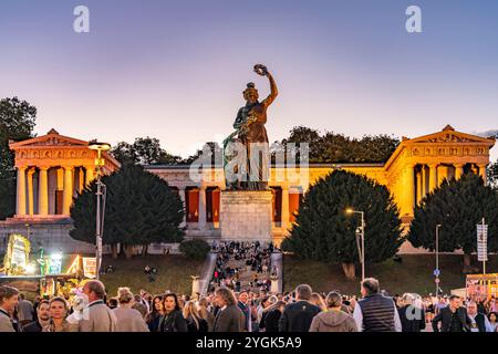 Ruhmeshalle, statua della Baviera e visitatori all'Oktoberfest 2024 al crepuscolo, Monaco, Baviera, Germania Foto Stock