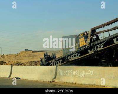 Giza, Egitto, ottobre 25 2024: I camion da costruzione pesanti per lo sviluppo vicino alla strada sulla tangenziale di Giza, progetti immobiliari egiziani e. Foto Stock