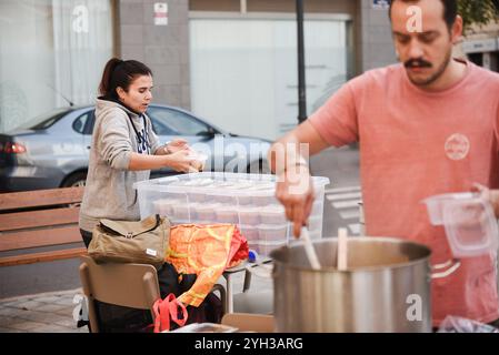 Valencia, Spagna - 9 novembre 2024. Vita quotidiana dopo la catastrofe DANA. Le persone sostengono le città colpite attraverso diverse azioni di aiuto. Il proprietario del ristorante MO e la sua cucina e preparazione per la consegna di cibo caldo fresco da inviare a diversi punti di controllo nell'area Ground zero. Le persone in questa zona spesso non possono lasciare la propria casa essendo anziane o a causa delle condizioni delle strade ancora ricoperte di fango. Aiutare le persone a preparare il cibo in tupati pronti per essere consegnati a chi ne ha bisogno. Crediti: Roberto Arosio/Alamy Live News Foto Stock