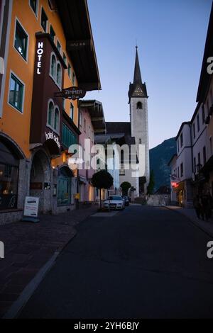 Golling an der Salzach, Austria - 27 giugno 2021: Strada con un hotel e una chiesa a Golling an der Salzach in una serata estiva. Foto Stock