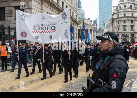 Gruppo di allievi volontari della polizia alla sfilata del Lord Mayor's Show 2024 nella City di Londra, Regno Unito. Evento storico e tradizionale. Con un agente di polizia armato Foto Stock