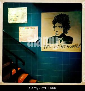 A portrait of American singer-songwriter Bob Dylan with a sign reading Times they are Changin' is displayed on a high school wall in Prado del Rey, Cadiz province, Andalusia, Spain Stock Photo