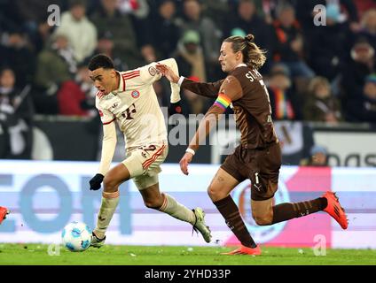 AMBURGO, GERMANIA - 9 NOVEMBRE: Jamal Musiala del Bayern Muenchen , Jackson Irvine von FC St. Pauli durante la partita di Bundesliga tra FC St. Pauli 1910 e FC Bayern München al Millerntor Stadium il 9 novembre 2024 ad Amburgo, Germania. © diebilderwelt / Alamy Stock Foto Stock