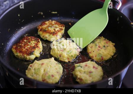Cucina sveva, preparazione di cavolo sabaudo, medaglioni di cinghiale con torte di cavolo sabaude, frittura di torte di verdure, padella, spatola, sano, cuoco casalingo Foto Stock