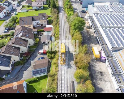 Vista aerea di un'area residenziale con binari ferroviari adiacenti ed edifici industriali al sole, macchina per compattazione, Hermann Hessebahn, Althengst Foto Stock