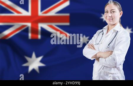 Medico donna sulla bandiera dell'Australia. Medico con le braccia incrociate sulla bandiera australiana. Concetto australiano di salute e assistenza Foto Stock