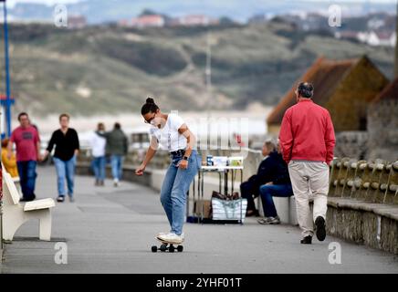 Skateboard donna sul lungomare di Ambleteuse, Côte d'Opale, Francia settentrionale. Foto Stock