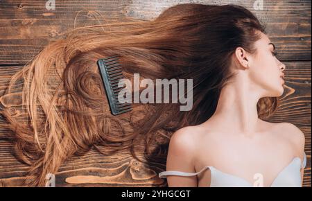 Bella ragazza bruna in movimento con capelli perfettamente lisci. Bruna con capelli lunghi e luminosi ondulati. Splendido modello con acconciatura riccia Foto Stock