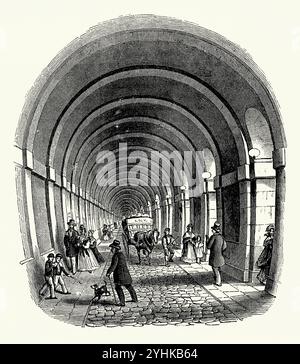 Il Tamigi Tunnel - un'antica incisione c.1850. Il tunnel si trova sotto il Tamigi a Londra, collegando Rotherhithe e Wapping. Misura 35 piedi (11 m) di larghezza per 20 piedi (6 m) di altezza ed è 1.300 piedi (396 m) di lunghezza, che scorre sotto il fiume. Fu il primo tunnel ad essere stato costruito con successo sotto un fiume navigabile. Utilizzando la nuova tecnologia di scudo di tunnel di Marc Isambard Brunel e Thomas Cochrane, fu costruito tra il 1825 e il 1843 da Brunel e suo figlio Isambard Kingdom Brunel. Foto Stock