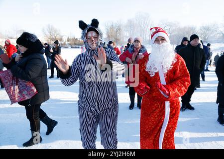 Ucraina, la città di Romny, 19 gennaio 2022: La festa del Battesimo del Signore. Il rito ortodosso di fare il bagno in una fossa. Epifania. Rari carolers e. Foto Stock