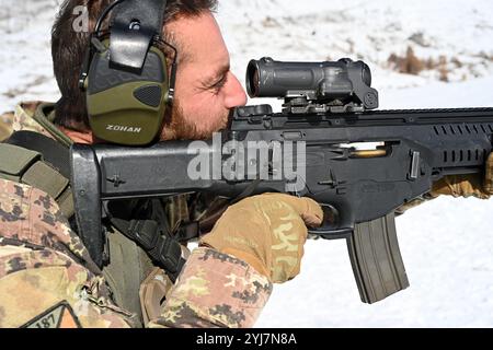 Un soldato dell'esercito italiano assegnato al 187° Reggimento paracadutisti "Folgore", ingaggia bersagli durante un'esercitazione di tiro all'interno del telaio Foto Stock