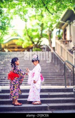 Ragazza nello yukata che gioca a forbici da carta rock Foto Stock