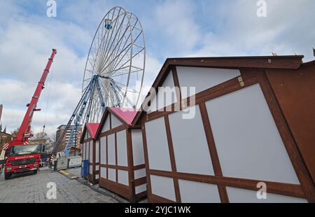 Rostock, Germania. 14 novembre 2024. Le prime bancarelle del mercato di Natale sono allestite a Neuer Markt, la ruota panoramica ha la sua prima funivia. Il mercato di Natale di Rostock è considerato il più grande della Germania settentrionale e apre dal 25.11. Al 22.12.2024. Crediti: Bernd Wüstneck/dpa/Alamy Live News Foto Stock